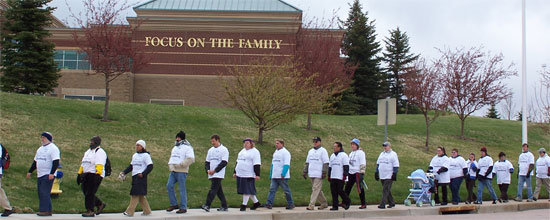 Soulforce volunteers march around the Focus on the Family campus